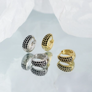 Detailed close-up of S925 sterling silver huggie earrings with black pavé crystals