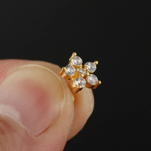 Golden stainless steel stud earrings featuring a flower design with five clear gemstones