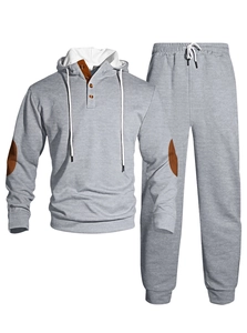 Detail of grey waffle knit tracksuit showing textured fabric and brown button placket