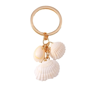 Handmade shell keychain with golden chain and natural white seashells on white background