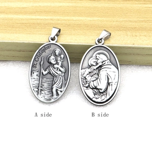 Macro shot of St. Christopher oval pendant showing detailed front and back relief engravings