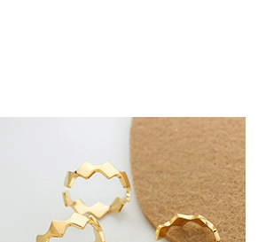 Detailed macro view of 18K gold plated C-shaped earrings with unique geometric zigzag design
