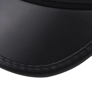 Macro detail of high-quality black PU leather texture and precise edge stitching on cap