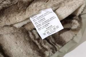 Detail of soft faux fur lining and laundry care label on men's winter cotton jacket