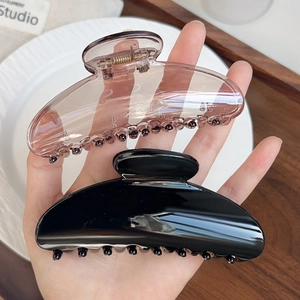 Elegant semi-round hair claw clips in translucent pink and glossy black set for women