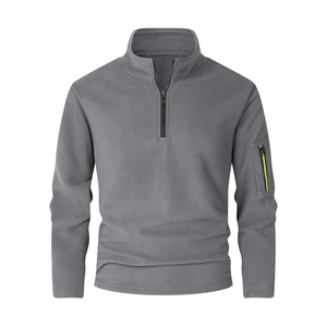 Detail of men's fleece pullover featuring stand collar and sleeve zipper pocket