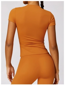 Rear view of vibrant orange high-stretch yoga set with slim fit leggings and top