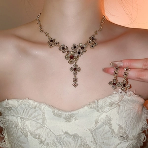 Vintage gold-plated floral jewelry set with ruby stones on an elegant female model