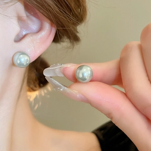 Elegant vintage grey faux pearl geometric stud earrings worn by a model for daily style