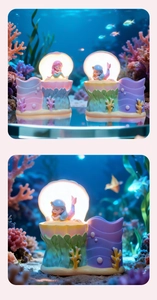 Close-up of pink and purple mermaid shell night light pencil holders with glowing feature