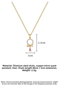 Detail of titanium steel necklace with gold bow, pink teardrop pendant and crystal ring