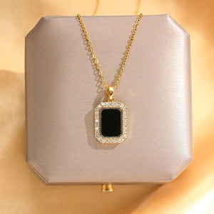 Detail view of gold titanium square necklace with black inlay and zirconia border