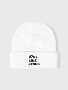 Detailed view of Love Like Jesus embroidery on a white cuffed winter knit beanie