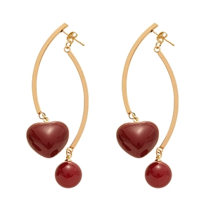 Vintage gold heart and pearl earrings with deep red resin pendants on a white background