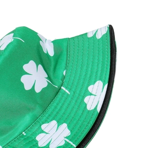 Close-up of green bucket hat with white shamrock pattern and detailed brim stitching