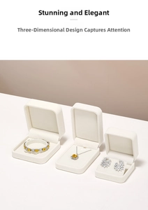 Detailed macro view of silver jewelry set with yellow gemstones in a white velvet gift box