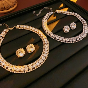 Exquisite gold and silver jewelry sets with round and oval crystals on black velvet