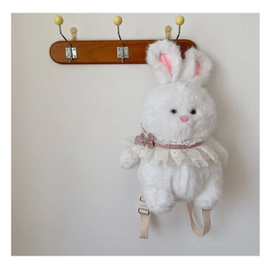 Detail of white plush bunny backpack with pink ears lace collar and adjustable straps