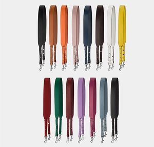 Detailed flat lay of adjustable leather bag straps in multiple vibrant solid colors