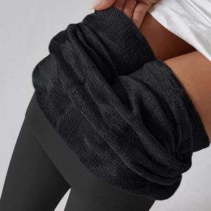 Close-up of thick fleece lining and elastic high waistband on black thermal leggings
