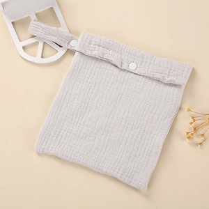 Detail of grey muslin stroller bag with adjustable snap button handle strap and soft texture