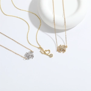 Gothic heart lock and windmill necklaces with sparkling zircons on white background
