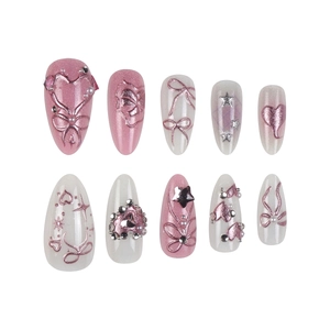 3D bow press-on nails with pink blush design and pearly star metal heart charms