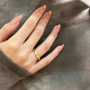 Detail of gold plated twisted rope ring showing the textured finish on finger