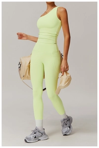Close-up of neon green one-shoulder yoga vest and high-waist leggings with matte finish