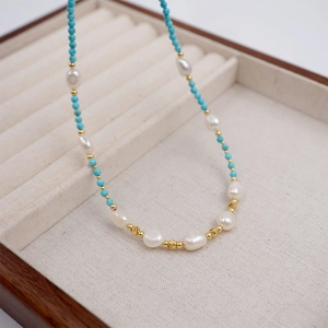 Handcrafted necklace set with turquoise beads, freshwater pearls and gold accents in a box