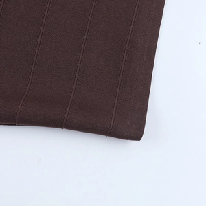 Close-up of dark brown vertical ribbed knit fabric texture showing elastic material detail