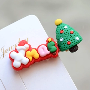 Close-up of Xmas letter and Christmas tree hair clip on a white jewelry display card