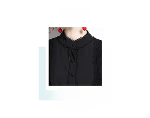 Close-up of elegant black lace collar with ball trim and single-breasted button detail
