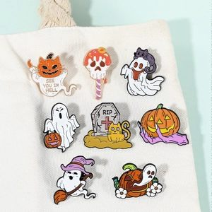 Set of 8 Halloween enamel pins with ghost and pumpkin designs on white canvas bag