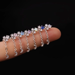 Silver stainless steel moon chain earrings with colorful zircon stones held on fingers