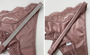 Detail view of lace and satin thong with sparkling rhinestone waistbands