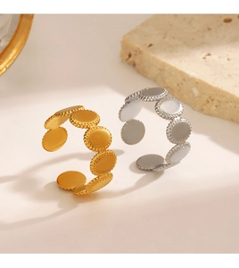 Close-up of geometric oval rings in gold and silver with a refined satin metal texture