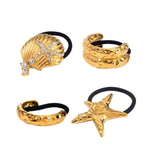 Set of four gold geometric hair ties with seashell, starfish and hammered metal charms