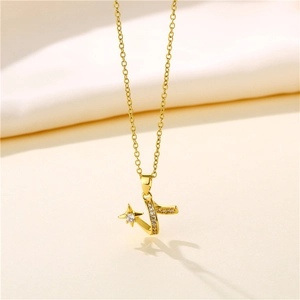 Close-up of gold star and Z-shape pendant with clear diamonds on a wavy chain