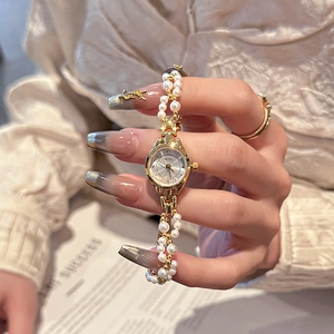 Elegant gold quartz watch for women featuring white pearl and metal bead bracelet strap