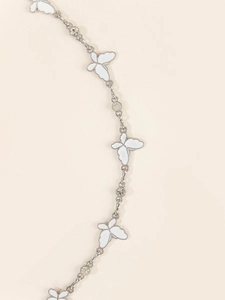Detail of silver butterfly waist chain with white enamel pendants and sparkly rhinestones