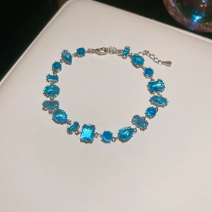 Detailed shot of silver-toned bracelet featuring various light blue multi-cut gemstones