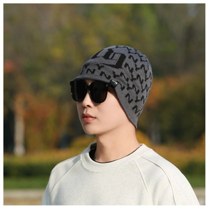 Detail of men's grey knit hat with brim and jacquard pattern for winter warmth