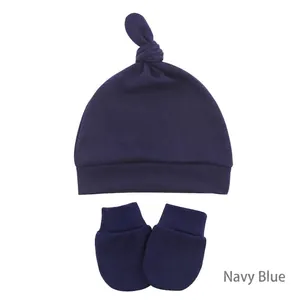 Detail of navy blue newborn knot hat and scratch mittens set in soft cotton knit