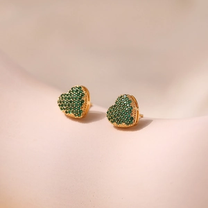 Close-up of heart stud earrings with green zircon pave setting in 18K gold plated copper