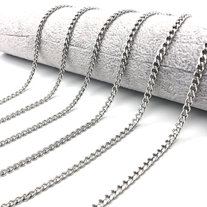Classic silver stainless steel Cuban link anklets displayed on a gray jewelry stand