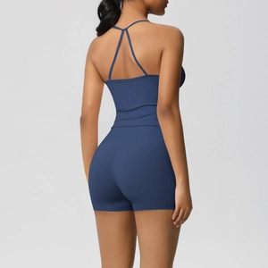 Detail of cross-strap back design on navy blue athletic yoga tank top for women