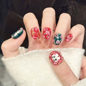 Vintage red rose press-on nails with cartoon charms and festive gold calligraphy