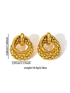 Detailed view of large gold hoop earrings featuring dual textured and polished metal rings