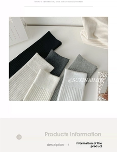 Detailed close-up of ribbed cotton knee-high socks in black, grey, and white tones
